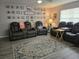 Living room with three black leather reclining chairs and area rug at 462 Cameo Dr # 462, Lakeland, FL 33803