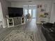 Spacious living room with grey wood-look flooring and a view into the dining area at 462 Cameo Dr # 462, Lakeland, FL 33803