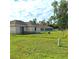 Large grassy backyard with chain link fence at 522 Raymond Ave, Frostproof, FL 33843