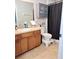 Clean bathroom with double vanity, shower/tub combo, and linen cabinet at 522 Raymond Ave, Frostproof, FL 33843