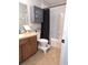 Clean bathroom with double vanity, shower/tub combo, and linen cabinet at 522 Raymond Ave, Frostproof, FL 33843