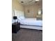 Cozy bedroom with full-size bed, nightstand, and carpeted floor at 522 Raymond Ave, Frostproof, FL 33843