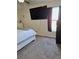 Spacious bedroom with large TV, carpeted floor, and ample natural light at 522 Raymond Ave, Frostproof, FL 33843