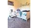 Bedroom with crib, changing table, and baby swing at 522 Raymond Ave, Frostproof, FL 33843
