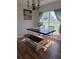 Bright dining room with a farmhouse table and bench seating at 522 Raymond Ave, Frostproof, FL 33843