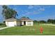 One-story home with attached garage and a well-maintained lawn at 522 Raymond Ave, Frostproof, FL 33843