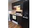 Kitchen features dark cabinets, electric range, and a built-in water dispenser at 522 Raymond Ave, Frostproof, FL 33843