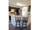 Kitchen with breakfast bar and dark brown cabinets at 522 Raymond Ave, Frostproof, FL 33843