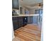 Open concept kitchen with dark cabinetry, dishwasher, and vinyl flooring at 522 Raymond Ave, Frostproof, FL 33843