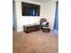 Living room featuring a large TV and comfy rocking chair at 522 Raymond Ave, Frostproof, FL 33843