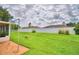 Grass yard with small patio and white fence at 3258 Triple Crown Ln, Lakeland, FL 33811