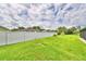 Large grassy backyard with white vinyl fence at 3258 Triple Crown Ln, Lakeland, FL 33811
