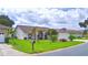 House front with nicely landscaped lawn at 3258 Triple Crown Ln, Lakeland, FL 33811