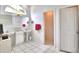 Bright bathroom with double vanity, pedestal sink, and tiled floor at 3258 Triple Crown Ln, Lakeland, FL 33811