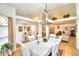 Spacious dining room featuring a large table, hardwood floors, and a modern chandelier at 3258 Triple Crown Ln, Lakeland, FL 33811