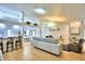 Open living room with a sectional sofa, hardwood floors, and views into the dining area at 3258 Triple Crown Ln, Lakeland, FL 33811