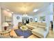 Comfortable living room featuring a sectional sofa, hardwood floors, and a cozy fireplace at 3258 Triple Crown Ln, Lakeland, FL 33811