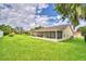 Large backyard with screened porch and lush lawn at 3258 Triple Crown Ln, Lakeland, FL 33811