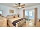 Bright bedroom with a queen-size bed and sliding doors to sunroom at 3258 Triple Crown Ln, Lakeland, FL 33811