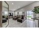 Living room with sectional sofa, large TV, and access to backyard at 653 Hidden Lakes Ct, Haines City, FL 33844