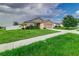 Tan one-story house with a two-car garage at 653 Hidden Lakes Ct, Haines City, FL 33844