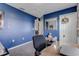 Home office with a desk and blue walls at 653 Hidden Lakes Ct, Haines City, FL 33844