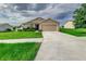 Tan one-story house with a two-car garage at 653 Hidden Lakes Ct, Haines City, FL 33844