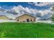 Large backyard with grassy area and home view at 653 Hidden Lakes Ct, Haines City, FL 33844