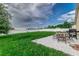 Backyard with patio, grassy area, and a privacy fence at 653 Hidden Lakes Ct, Haines City, FL 33844