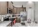 Modern kitchen with stainless steel appliances and ample cabinet space at 653 Hidden Lakes Ct, Haines City, FL 33844