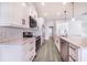 White kitchen with marble countertops and stainless steel appliances at 5017 Ridgefield Lane, Lakeland, FL 33812