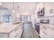 Modern kitchen featuring white cabinets, marble countertops, and stainless steel appliances at 5017 Ridgefield Lane, Lakeland, FL 33812
