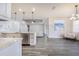 Modern kitchen boasts white cabinets, marble counters, and stainless steel appliances at 5017 Ridgefield Lane, Lakeland, FL 33812