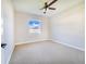 Bright bedroom featuring carpet flooring and a ceiling fan at 5017 Ridgefield Lane, Lakeland, FL 33812
