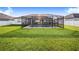 Expansive backyard featuring a screened pool and lush lawn at 5017 Ridgefield Lane, Lakeland, FL 33812