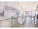 Open kitchen with white cabinets, marble countertops, and an island at 5017 Ridgefield Lane, Lakeland, FL 33812