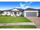 House exterior showcasing a two-car garage, landscaped yard, and a paved driveway at 5017 Ridgefield Lane, Lakeland, FL 33812