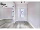 Bright entryway with gray wood-look flooring, white door, and access to other rooms at 5017 Ridgefield Lane, Lakeland, FL 33812
