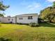 White single-story house with a green lawn at 619 Cassandra Ln, Lakeland, FL 33809