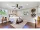 Cozy bedroom with hardwood floors, neutral decor, and ceiling fan at 215 W Carter Rd, Lakeland, FL 33813