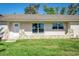 Front view of a renovated home with stonework at 215 W Carter Rd, Lakeland, FL 33813