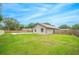 Large backyard with grassy area and wooden fence at 4500 Old Colony Rd, Mulberry, FL 33860