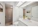 Updated bathroom with gray tile shower and white vanity at 4500 Old Colony Rd, Mulberry, FL 33860