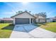 House exterior with attached garage and stone feature at 4500 Old Colony Rd, Mulberry, FL 33860