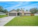 Newly renovated house with a stone chimney and a spacious lawn at 4500 Old Colony Rd, Mulberry, FL 33860