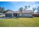 Charming house exterior with stone fireplace and garage at 4500 Old Colony Rd, Mulberry, FL 33860