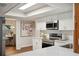 Modern kitchen with white cabinets, stainless steel appliances, and quartz countertops at 4500 Old Colony Rd, Mulberry, FL 33860