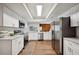 Modern kitchen with white cabinets, stainless steel appliances, and light wood floors at 4500 Old Colony Rd, Mulberry, FL 33860