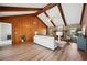 Open living room with wood walls, beamed ceiling, and stone fireplace at 4500 Old Colony Rd, Mulberry, FL 33860