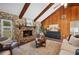Spacious living room with high ceilings, wood beams, and stone fireplace at 4500 Old Colony Rd, Mulberry, FL 33860